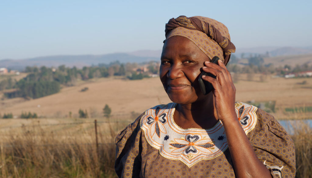 Traditional African Zulu woman speaking on mobile phone