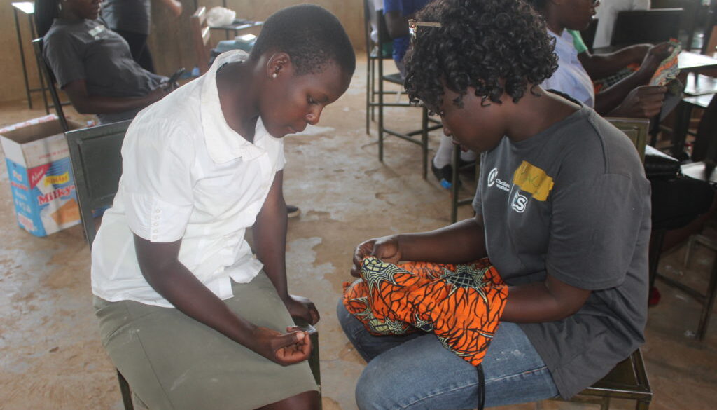 Health Impact Day Uganda: Girls makeng their bag